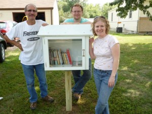 From left to right: My dad, who built and installed the library, my husband, and me.